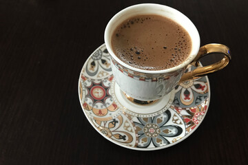 Traditional Turkish coffee cup with wooden background