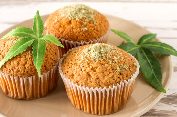 Cupcake with marijuana. Tasty cupcake muffins with cannabis weed cbd. Medical marijuana drugs in food dessert, ganja legalization.