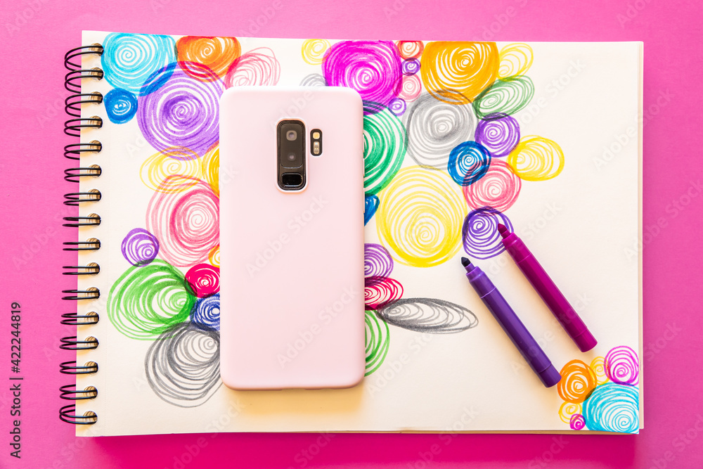 Poster top view of smartphone and markers with colorful spirals background