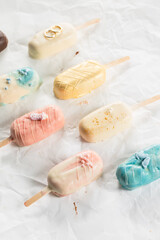 Obraz na płótnie Canvas Colored Ice Cream Bar on a Stick, pink, blue, yellow, wedding, brown 
