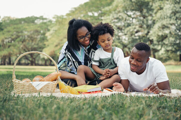 Happy picnic relax black people family with son in garden