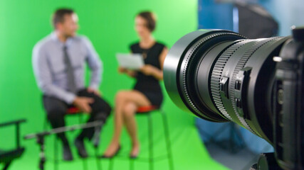 Recording live talk show between journalist and star at tv green screen studio
