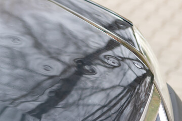 Car engine hood with many hail damage dents show the forces of nature and the importance of car...