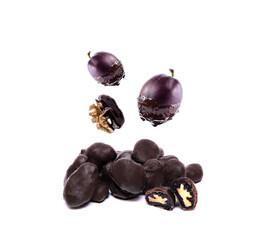dried plum covered by dark  chocolate with nuts , composition with fresh fruits in chocolate isolated on white background. free space for text and logo.
