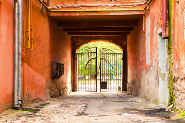 Fototapeta na wymiar walk-through arch with wrought-iron gates in an old house
