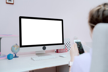 Monitor standing on white desk in teenage girl's room with copy space.