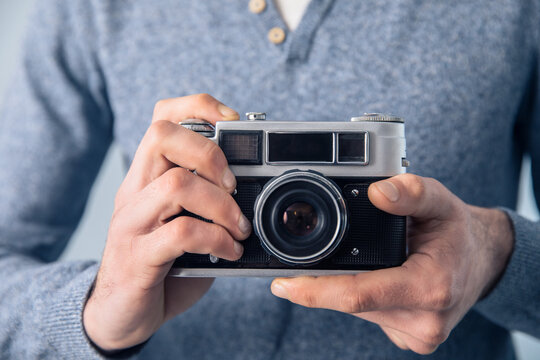 man holding vintage camera