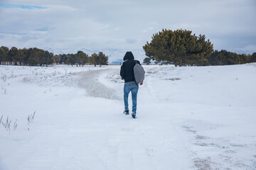 Fototapeta na wymiar traveler man in snowy nature