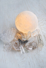 Moon lamp, healing gemstones, Death's head hawk moth butterfly, on wooden background. clear quartz....
