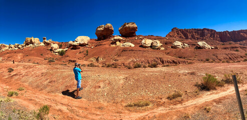 Male tourist photographing Capitol,Reef rock formations in summer season - Panoramic view