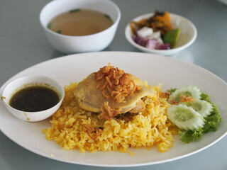 Chicken Biryani food, yellow color Traditional Indian dish of rice and chicken marinated in spices