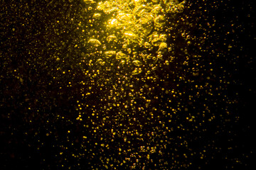 Fototapeta na wymiar Gold bokeh of lights from water