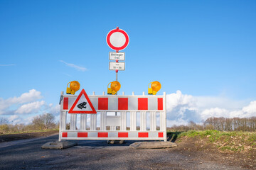 Roadblock with toad migration sign. Road closed with a barrier for protection of amphibians during...