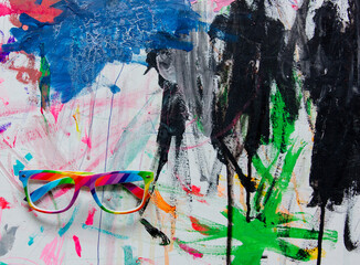 Glasses on a art paint as background. Above view