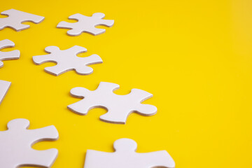 white puzzles isolated on yellow