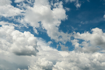 Naklejka na ściany i meble White clouds on a blue sky. Nature background.