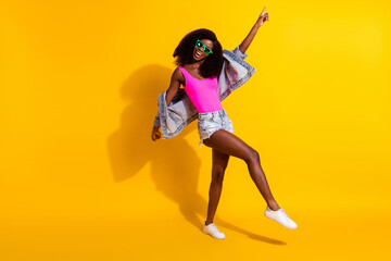 Fototapeta na wymiar Full body photo of charming afro american woman point finger dance disco isolated on yellow color background