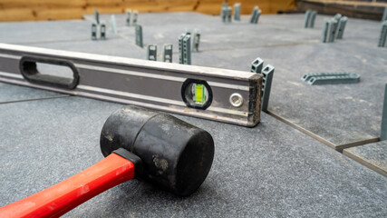 Rubber mallet and spirit level tools to build a patio