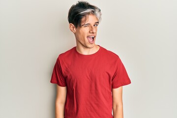 Obraz premium Young hispanic man wearing casual clothes winking looking at the camera with sexy expression, cheerful and happy face.