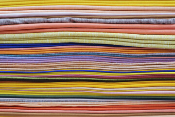 A stack of colorful fabrics. Multicolored background.