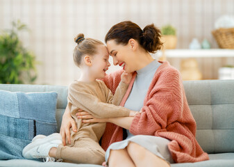 Mom and her daughter smiling and hugging