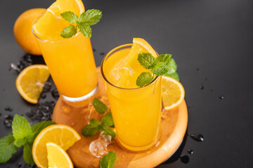 Fresh orange juice in glass with mint, fresh fruits. selective focus.