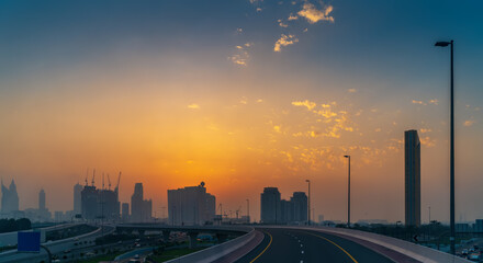 Dubai skyline at sunset, view from highway to downtown, UAE.