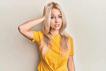 Beautiful caucasian blonde girl wearing casual tshirt confuse and wonder about question. uncertain...
