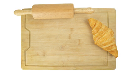 Freshly baked croissants and Rolling pin on wooden cutting board, top view. Crescent-shaped bread originated in France. The popular breakfast menu spread all over the world.