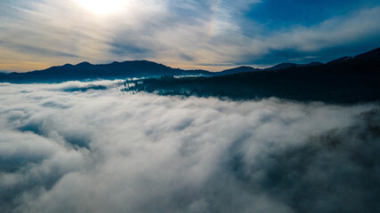 mountains tops high above clouds fog