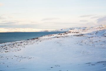 North sea coast with ice and snow. Tranquil frozen natural landscape. Horizontal photo with copy space. Banner for website header design