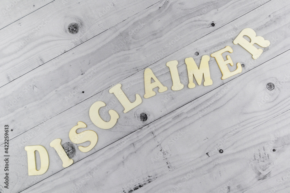 Fototapete disclaimer concept with undulating word in alphabet letters arranged diagonally on light grey planks