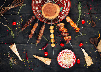 Variety of caucasian shashlyq skewers with different meat on the wooden background