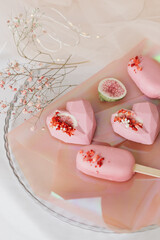 pink ice cream of different shapes on a tray