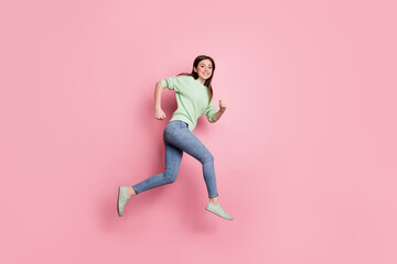 Fototapeta na wymiar Full size profile photo of brunette nice girl jump run wear lime sweater jeans sneakers isolated on pink color background