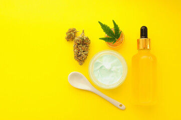 Cannabis cosmetics, cbd oil. Marihuana extract in cosmetology. Flat lay, yellow background. Home relaxation, spa recreation, pastime therapy.