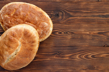 Fresh homemade wheat bread on  wooden table.