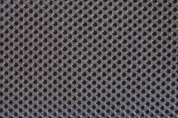 Dark gray textile surface with many small meshes. Orthopedic insert in the back of a modern backpack. Backdrop or background