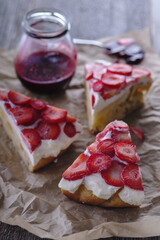 3 slices of homemade cream pie with fresh strawberries. In the background, a glass jar with jam