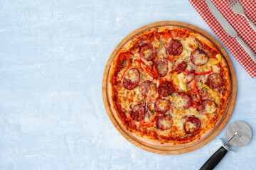 Delicious pizza with sausages on gray background