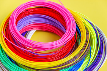 Kit colored PLA and ABS plastic filament for 3D printer and pen. Hobby for children. Close-up.