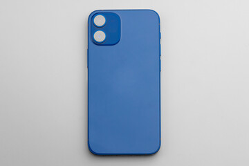 Blue modern smartphone with double-lens camera on gray background