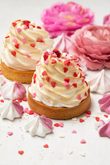 Mother's day holiday brunch with cupcake craem and pink flowers on white background