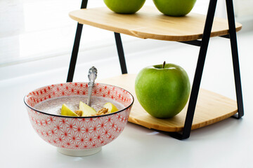 Flaxseed porridge with apples. Oatmeal porridge bowl with flax linen seeds. Healthy nutritious breakfast. Selective focus