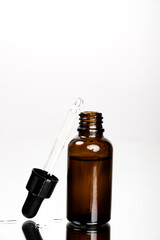Face skin and body care concept, Healthy natural cosmetics in dark glass reusable bottles. Hyaluronic acid with pipette.