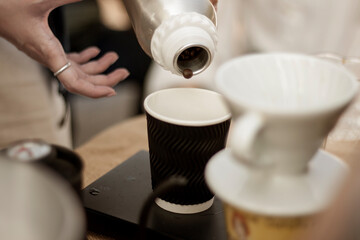 A  barista doing pour fresh coffee beans To make drip coffee.