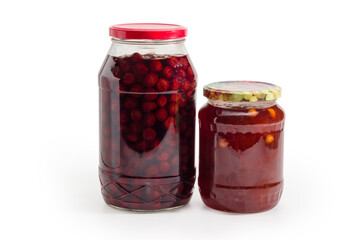Apricot jam and cherry jam in two glass jars