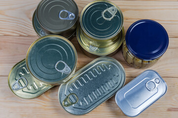 Canned fish in tin cans and glass jar, top view
