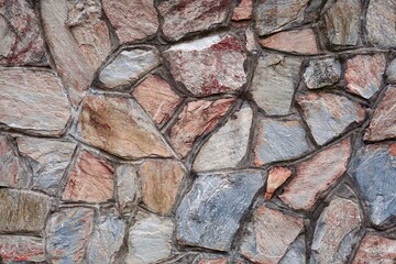 red stone building wall, textured abstract background