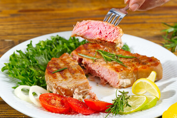 Tuna steak cooked on the electric grill. tunafish served on a plate with fresh herbs and vegetables. healthy nutritious, Healthy Eating for a Healthy Weight